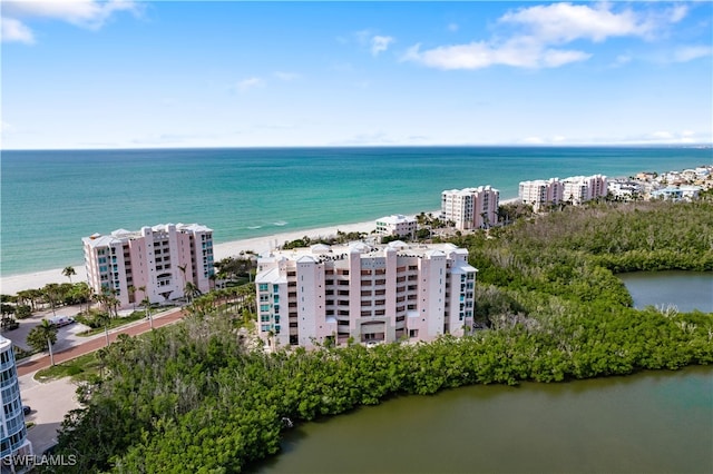 drone / aerial view featuring a view of the beach and a water view