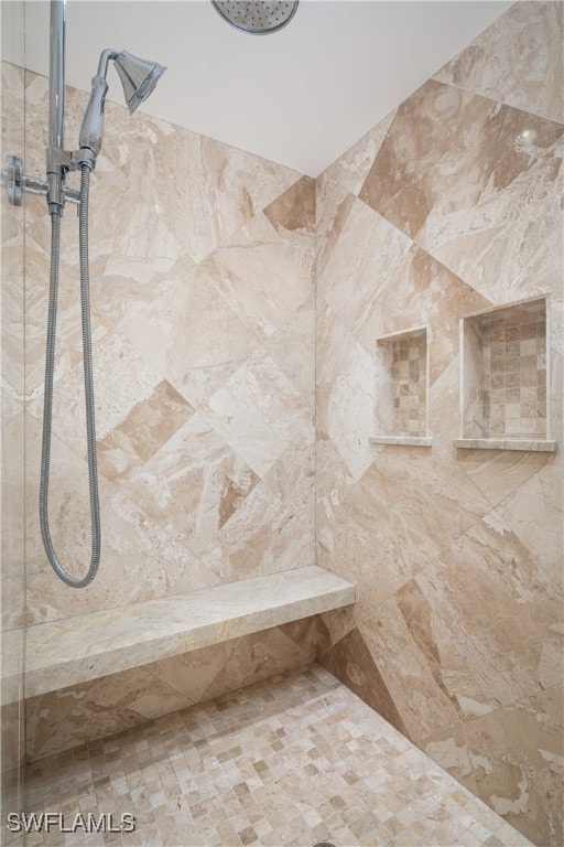 interior details featuring tiled shower