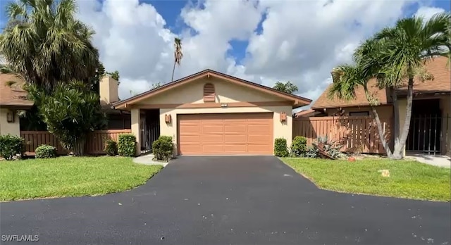 ranch-style house with a garage and a front lawn