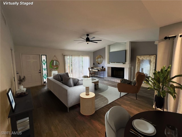 living room with vaulted ceiling, ceiling fan, and dark hardwood / wood-style flooring