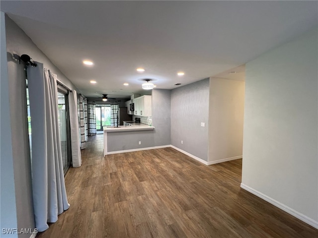 unfurnished living room featuring dark hardwood / wood-style floors