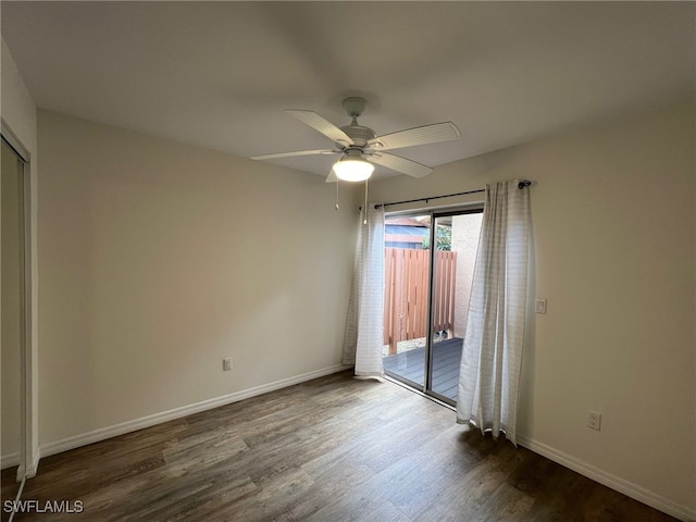 spare room featuring ceiling fan and dark hardwood / wood-style flooring