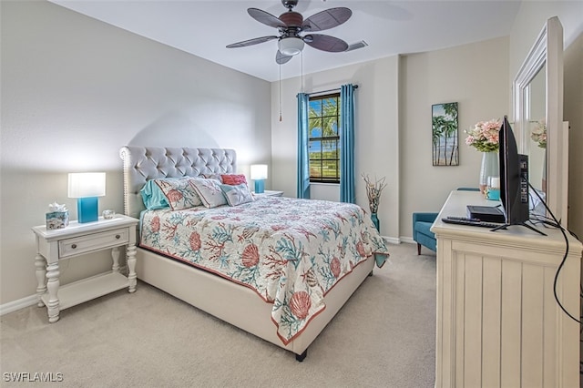 bedroom featuring a ceiling fan, light carpet, and baseboards