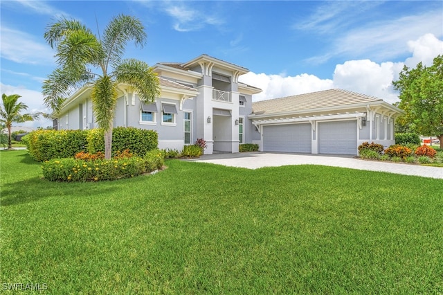 view of front of home featuring stucco siding, driveway, an attached garage, and a front lawn