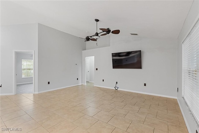 spare room with ceiling fan, light tile patterned floors, and high vaulted ceiling