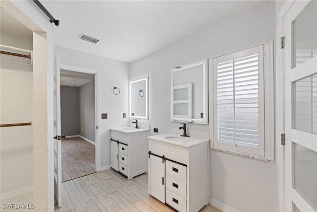 bathroom with vanity and hardwood / wood-style flooring