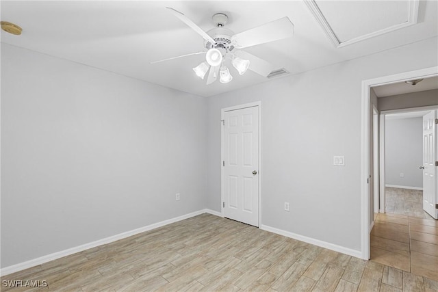 empty room featuring ceiling fan and light hardwood / wood-style flooring