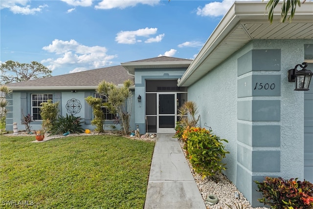 doorway to property with a yard