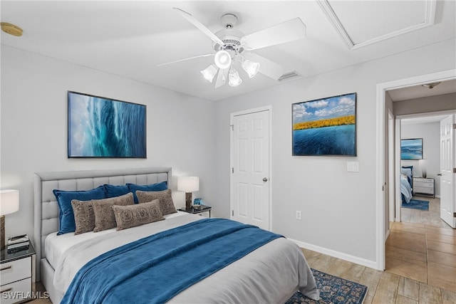 bedroom with ceiling fan and light hardwood / wood-style flooring