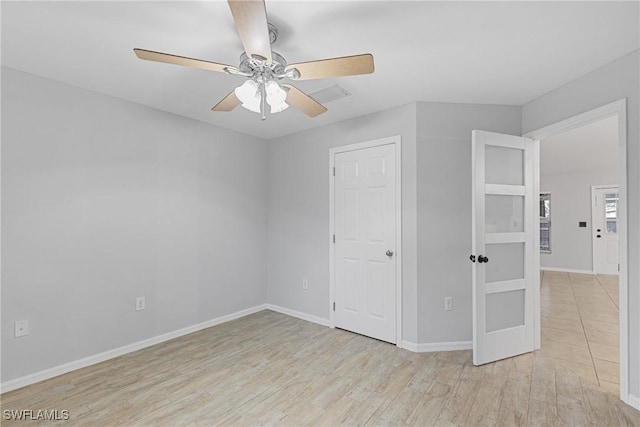 unfurnished bedroom with ceiling fan and light hardwood / wood-style floors