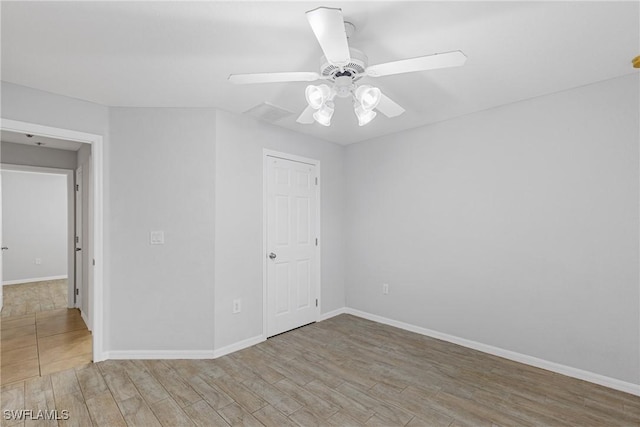 unfurnished room featuring ceiling fan and light wood-type flooring