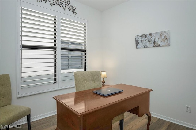 office space with wood finished floors and baseboards