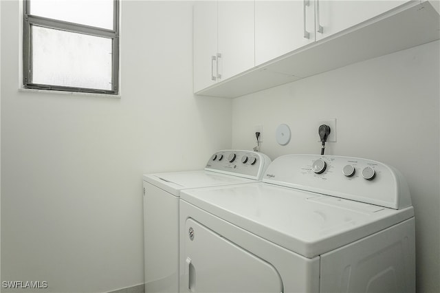 laundry area featuring cabinets and separate washer and dryer