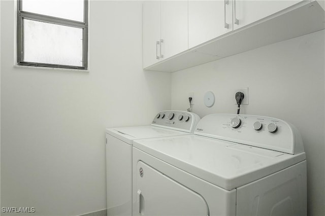laundry room featuring cabinet space and separate washer and dryer