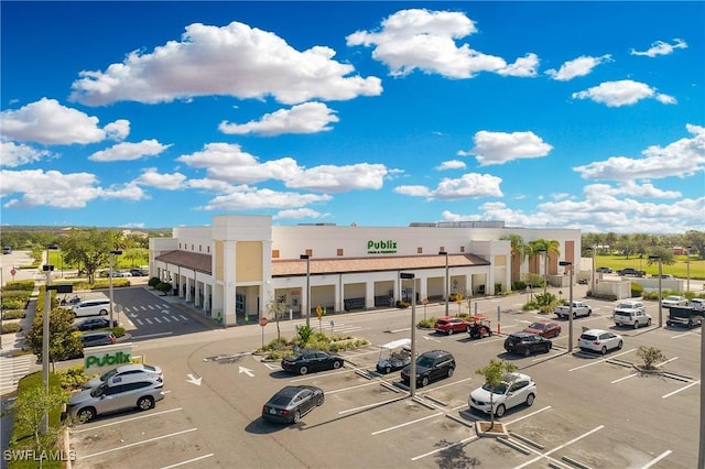 view of building exterior with uncovered parking