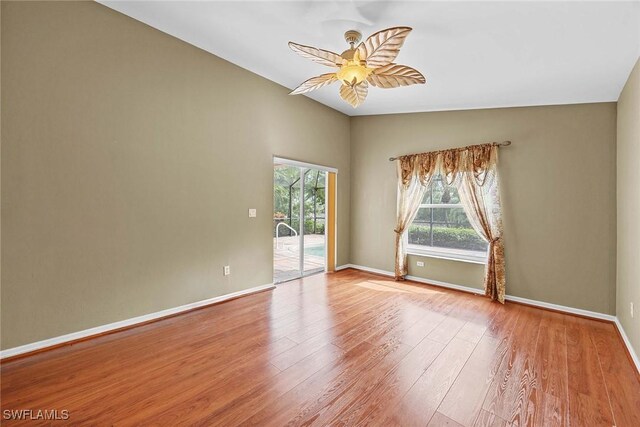 spare room with lofted ceiling, ceiling fan, and light hardwood / wood-style floors