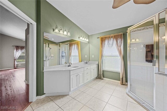 bathroom with lofted ceiling, wood-type flooring, a wealth of natural light, and vanity