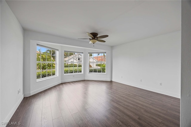 spare room featuring ceiling fan and dark hardwood / wood-style flooring