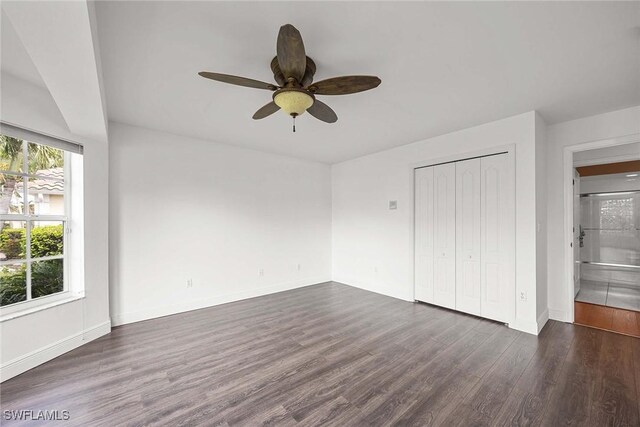 unfurnished bedroom featuring a closet, ensuite bathroom, ceiling fan, and dark hardwood / wood-style floors