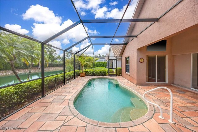 view of pool featuring a lanai, a water view, and a patio