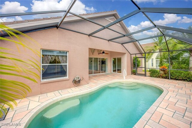 view of pool featuring ceiling fan, a patio, and a lanai