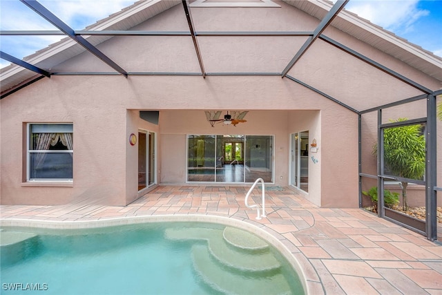 view of swimming pool featuring a lanai, a patio area, and ceiling fan