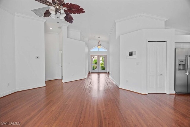 interior space with hardwood / wood-style floors, crown molding, ceiling fan, french doors, and lofted ceiling