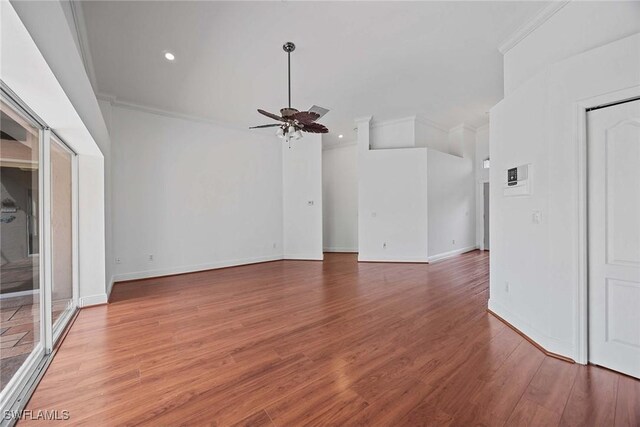 interior space featuring ceiling fan, hardwood / wood-style flooring, and ornamental molding