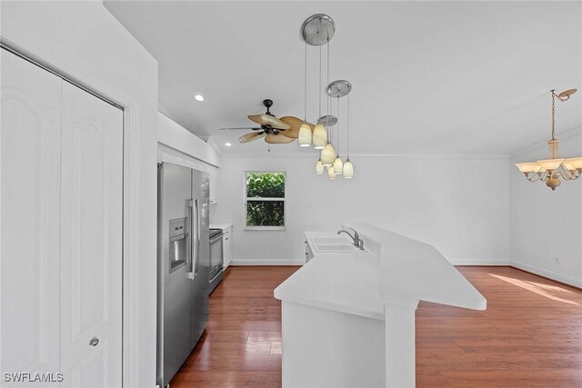 kitchen with pendant lighting, dark hardwood / wood-style flooring, sink, ceiling fan, and appliances with stainless steel finishes