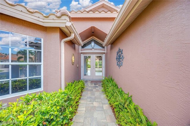 view of exterior entry featuring french doors