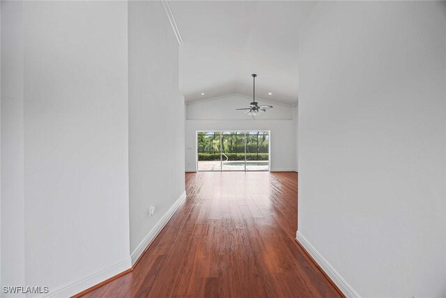 corridor featuring lofted ceiling and hardwood / wood-style floors