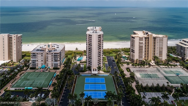 birds eye view of property with a water view and a view of the beach