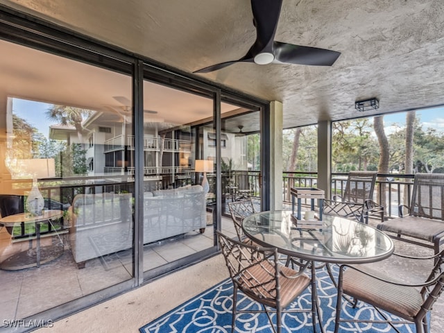 sunroom featuring ceiling fan