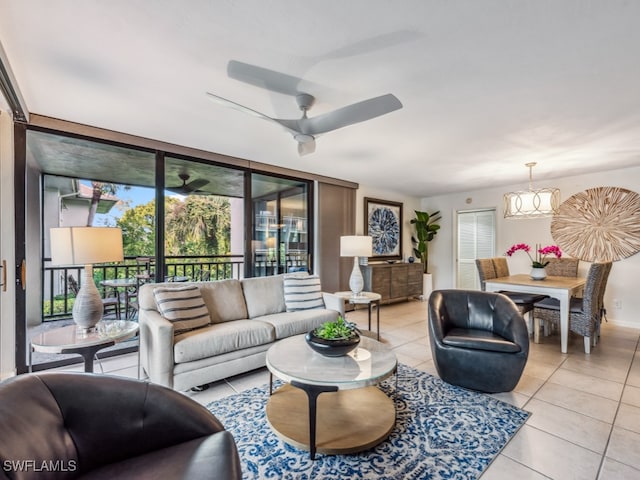 tiled living room featuring ceiling fan with notable chandelier