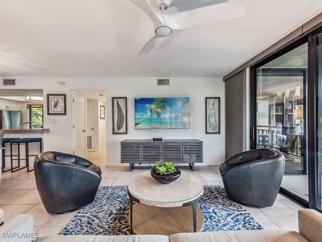 tiled living room featuring ceiling fan