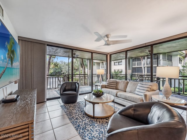 tiled living room with expansive windows, plenty of natural light, and ceiling fan