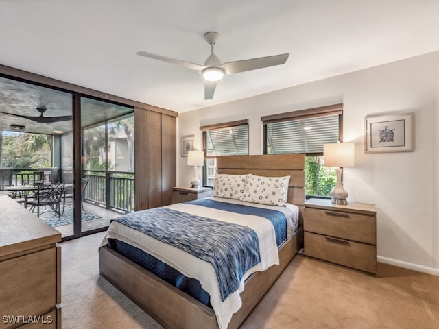 carpeted bedroom featuring ceiling fan, access to exterior, and multiple windows