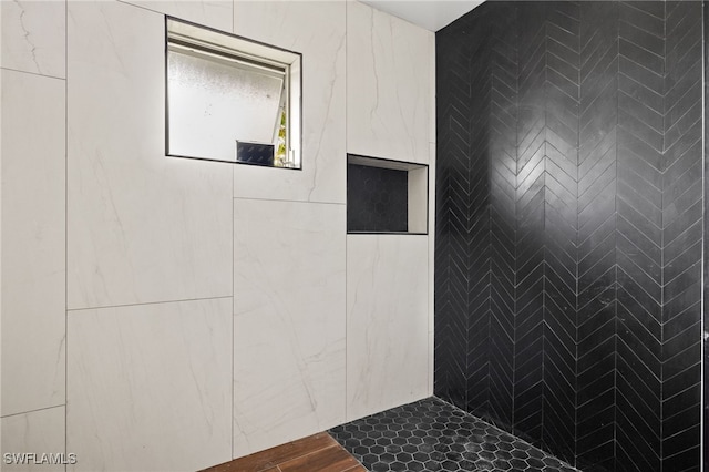 bathroom with a tile shower