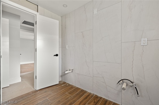 bathroom with tile walls and hardwood / wood-style flooring