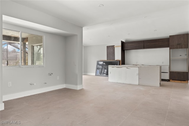 kitchen featuring dark brown cabinets and light tile patterned floors