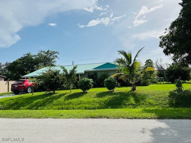 view of home's community featuring a lawn