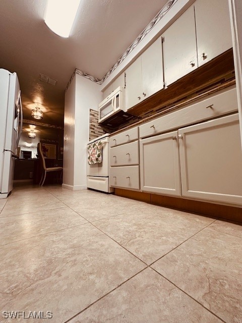 kitchen with white appliances and white cabinetry