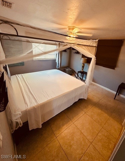 unfurnished bedroom featuring tile patterned floors and ceiling fan