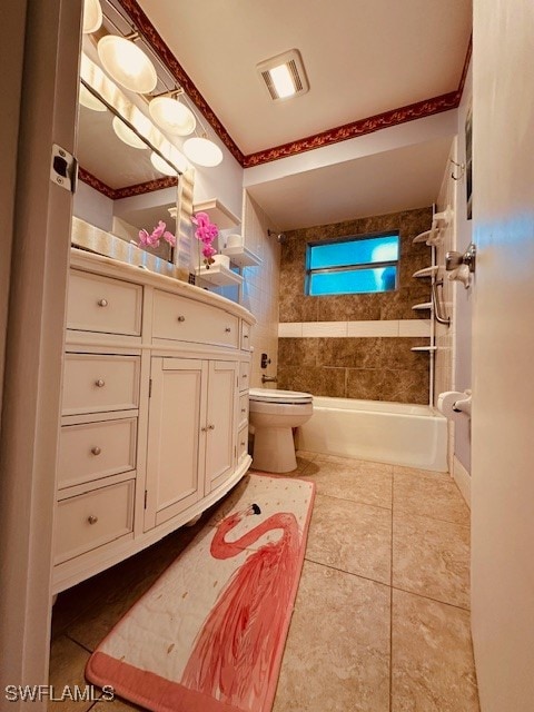 full bathroom with tiled shower / bath, vanity, toilet, and tile patterned floors