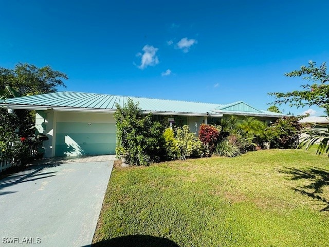 view of front of house with a front yard and a garage