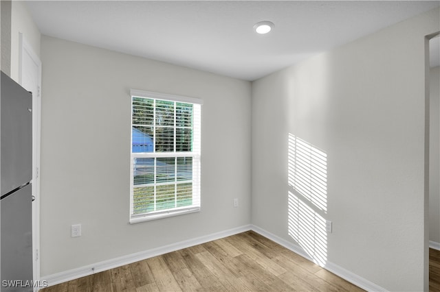 empty room with light hardwood / wood-style flooring