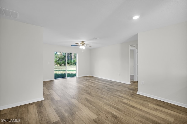 empty room featuring ceiling fan and hardwood / wood-style floors