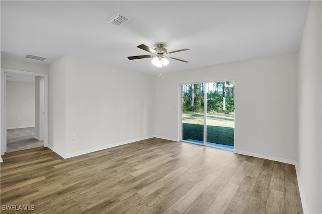 spare room featuring wood-type flooring and ceiling fan