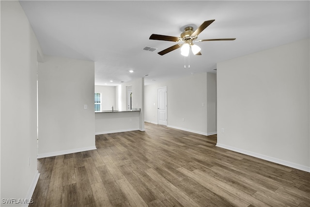 unfurnished living room with hardwood / wood-style floors and ceiling fan