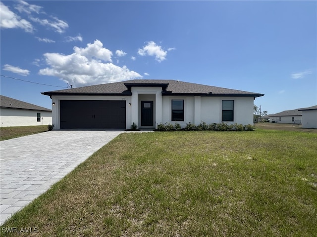249 Blackstone Dr, Fort Myers, FL 33913 - prairie-style home featuring a garage, decorative driveway, stucco siding, a front lawn, and a shingled roof